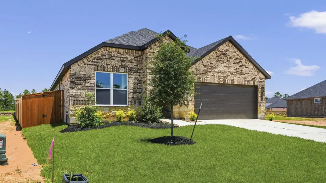 Front exterior of a new home in Mill Creek Estates, Magnolia, TX, highlighting curb appeal (Image 20). Front exterior of a new home in Mill Creek Estates, Magnolia, TX, highlighting curb appeal (Image 20).