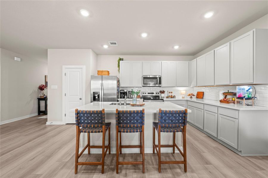 Culinary creations come to life in this kitchen, featuring an inviting island and abundant cabinetry. Culinary creations come to life in this kitchen, featuring an inviting island and abundant cabinetry.