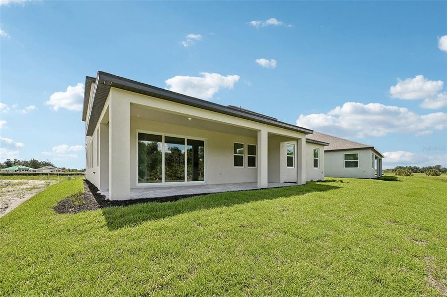 Exterior details and patio area of a home in Creeks Edge at Twin Rivers, Parrish (Image 3).