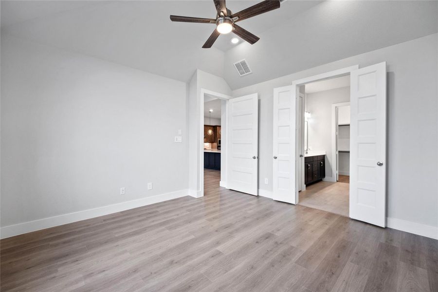 Additional view from primary bedroom looking towards the double door entrance to primary bathroom.