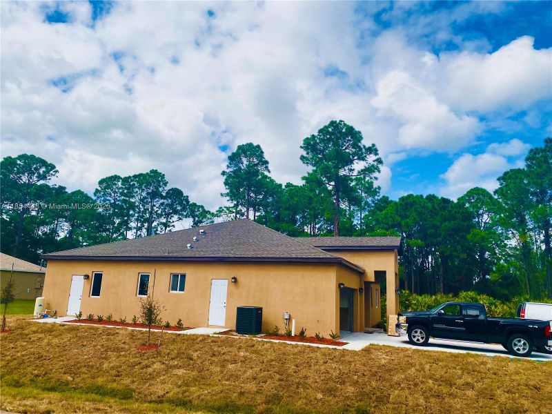 Front exterior of a new home in , Palm Bay, FL, highlighting curb appeal (Image 2). Front exterior of a new home in , Palm Bay, FL, highlighting curb appeal (Image 2).
