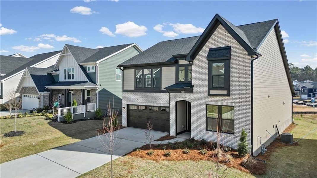 Front exterior of a new home in Twin Lakes, Hoschton, GA, highlighting curb appeal (Image 1). Front exterior of a new home in Twin Lakes, Hoschton, GA, highlighting curb appeal (Image 1).