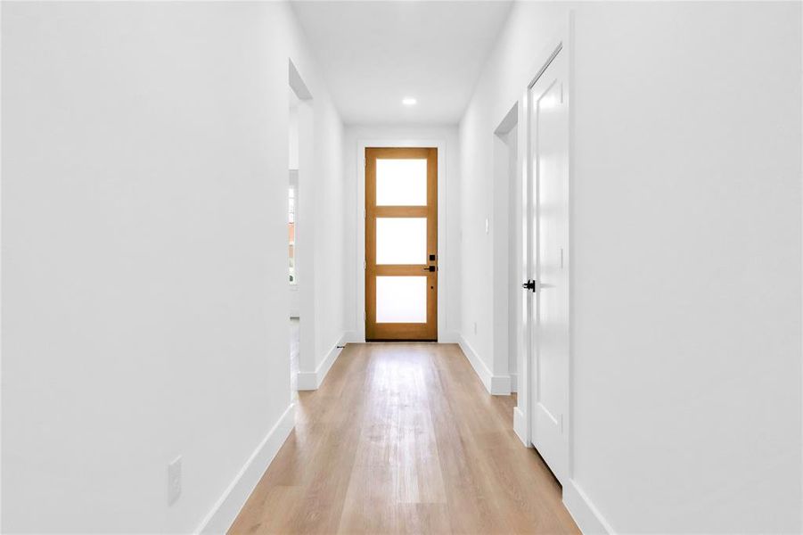 Hall featuring light wood-type flooring and recessed lighting