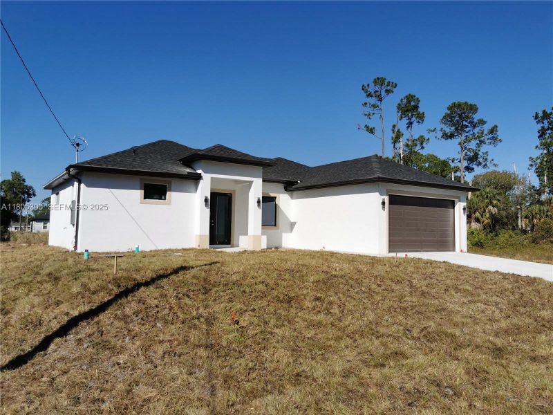 Front exterior of a new home in , Lehigh Acres, FL, highlighting curb appeal (Image 15).