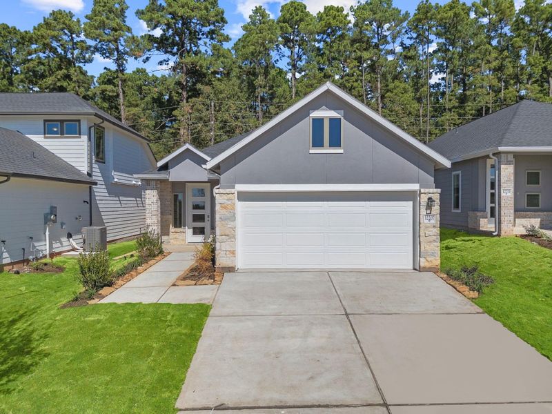 Front exterior of a new home in Westridge Cove, Conroe, TX, highlighting curb appeal (Image 1).