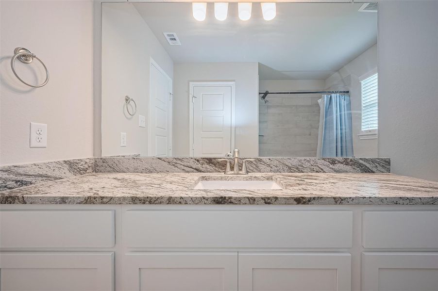 Furnished interior view inside a new home in Sunterra, Katy (Image 11).