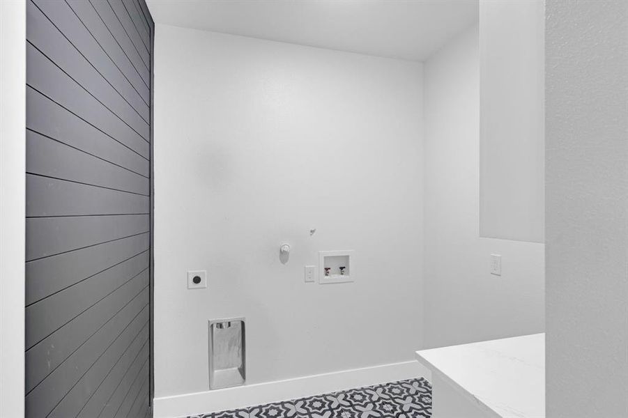 Laundry area with hookup for a gas dryer, hookup for a washing machine, and hookup for an electric dryer