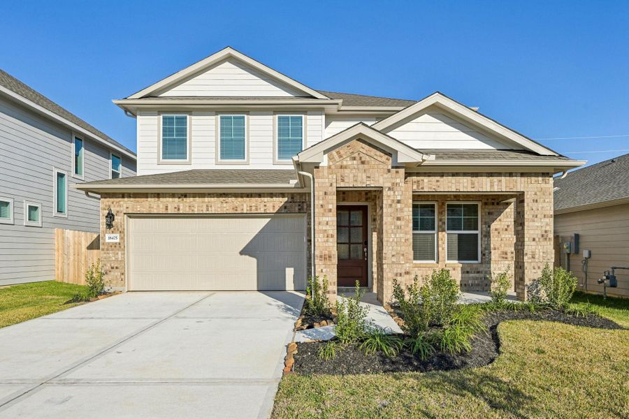 Front exterior of a new home in Landing Meadows - Premier Series, New Caney, TX, highlighting curb appeal (Image 21).