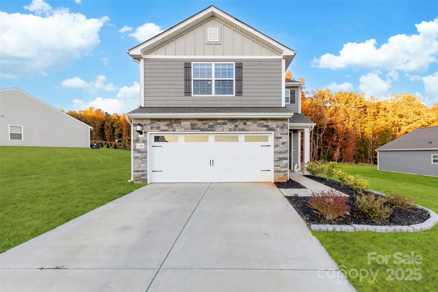 Front exterior of a new home in , Troutman, NC, highlighting curb appeal (Image 30).