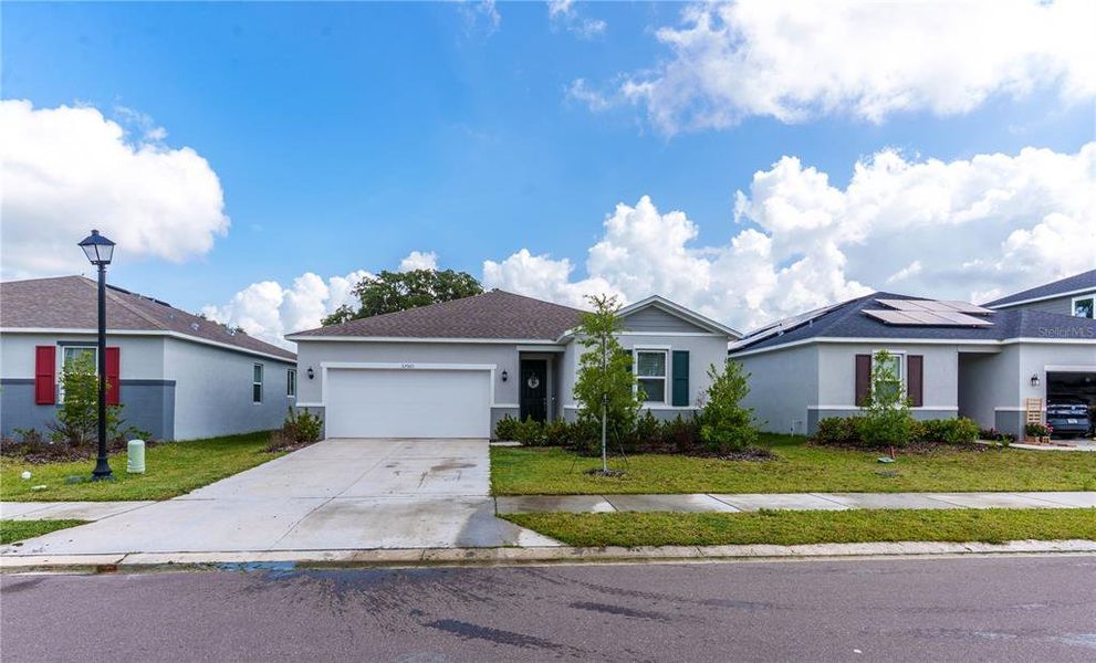 Front exterior of a new home in River Run II, Zephyrhills, FL, highlighting curb appeal (Image 2). Front exterior of a new home in River Run II, Zephyrhills, FL, highlighting curb appeal (Image 2).