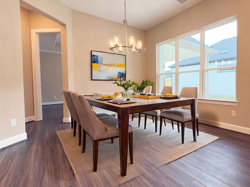 The dining room in the Portico at Winfrey Estates is an inviting open space that seamlessly connects the kitchen and private eating area to the living room.