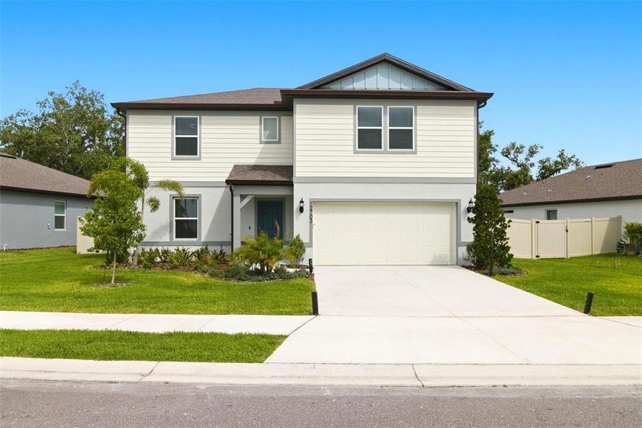 Front exterior of a new home in Oakfield Lakes, Parrish, FL, highlighting curb appeal (Image 1). Front exterior of a new home in Oakfield Lakes, Parrish, FL, highlighting curb appeal (Image 1).