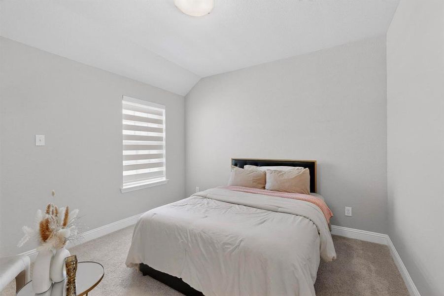 This room features a window with horizontal blinds, light-colored walls, and carpeting