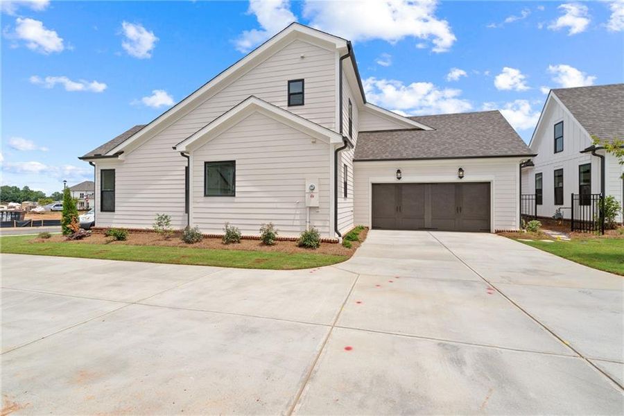 Front exterior of a new home in Promenade at Sawnee Village, Cumming, GA, highlighting curb appeal (Image 21).