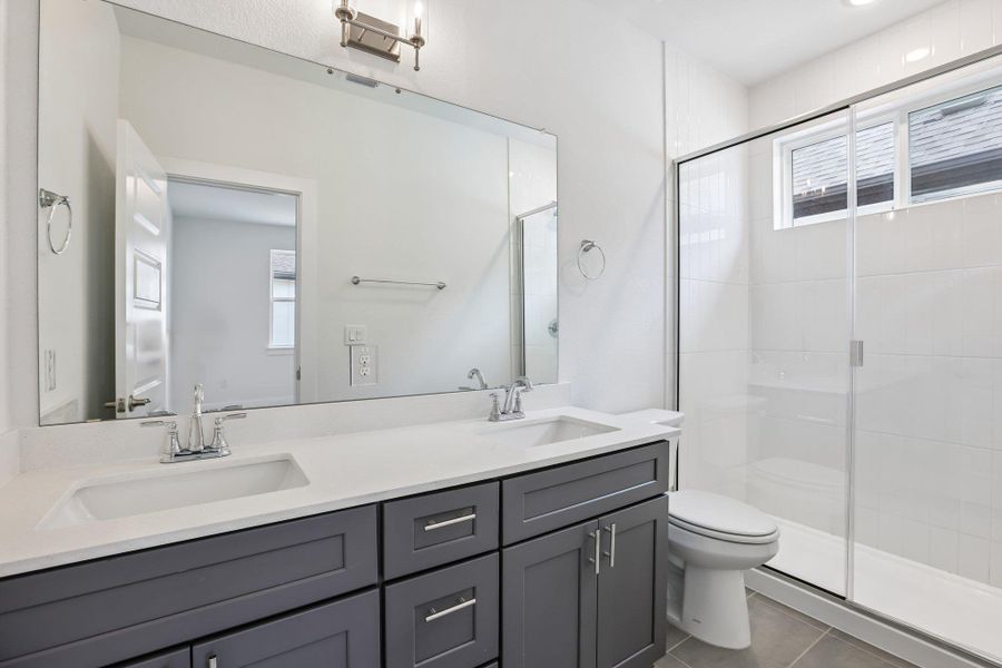 This ensuite features a dual quartzvanity.