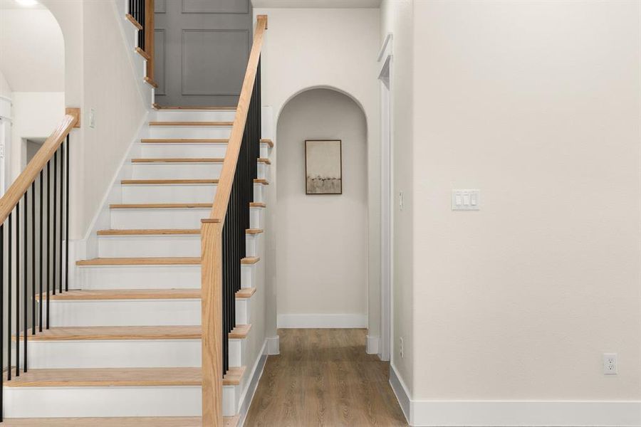 Stairway featuring baseboards and wood finished floors