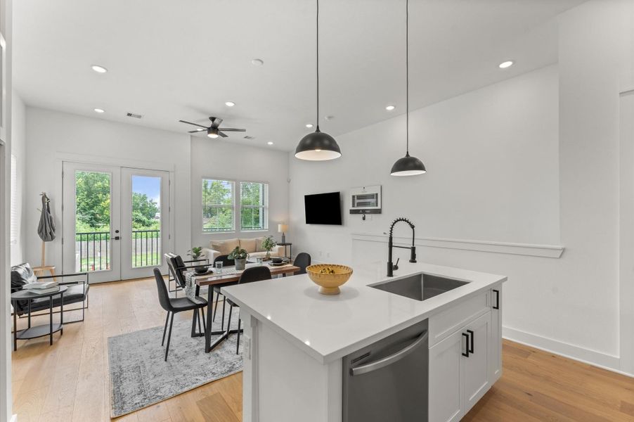 This stylish kitchen island anchors the heart of the home, offering clear sightlines to the adjacent living area and out through elegant French doors to the balcony. Positioned for both function and connection, the island features sleek countertops, bar seating, and pendant lighting that adds a touch of sophistication. This stylish kitchen island anchors the heart of the home, offering clear sightlines to the adjacent living area and out through elegant French doors to the balcony. Positioned for both function and connection, the island features sleek countertops, bar seating, and pendant lighting that adds a touch of sophistication.