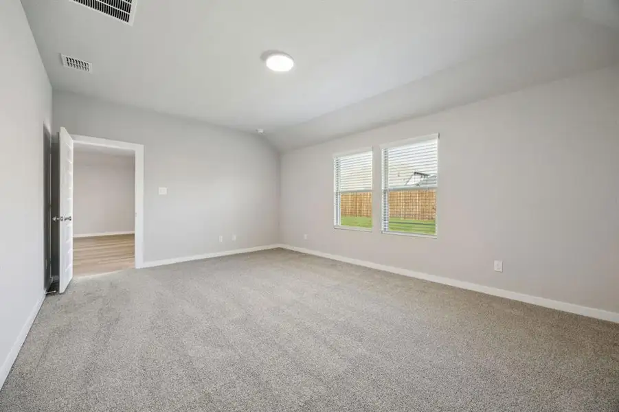 Primary Suite in the Oscar home plan by Trophy Signature Homes – REPRESENTATIVE PHOTO