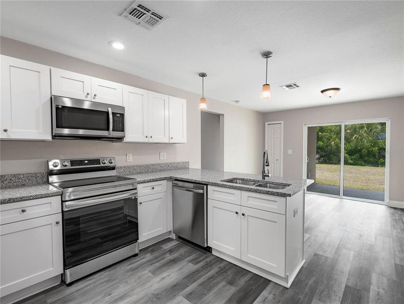 Kitchen and Dining room. Photos of a completed model. Actual finishes of this home home may not be the same as portrayed in these photos.