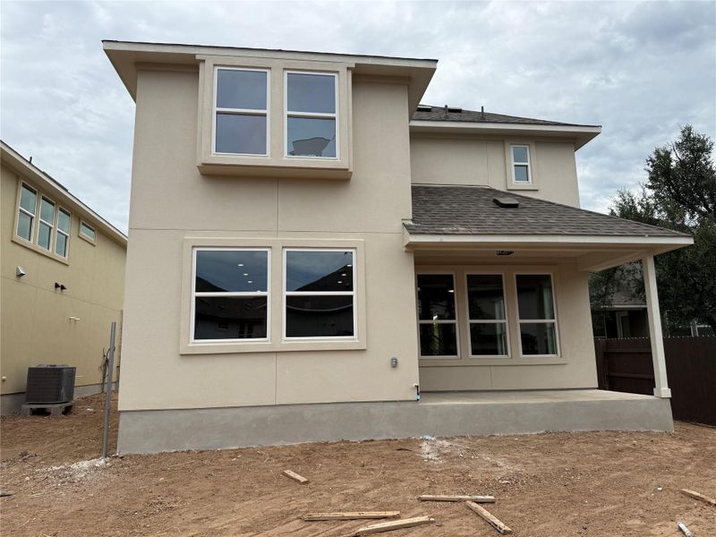 Rear view of house featuring roof with shingles, stucco siding, and a patio Rear view of house featuring roof with shingles, stucco siding, and a patio