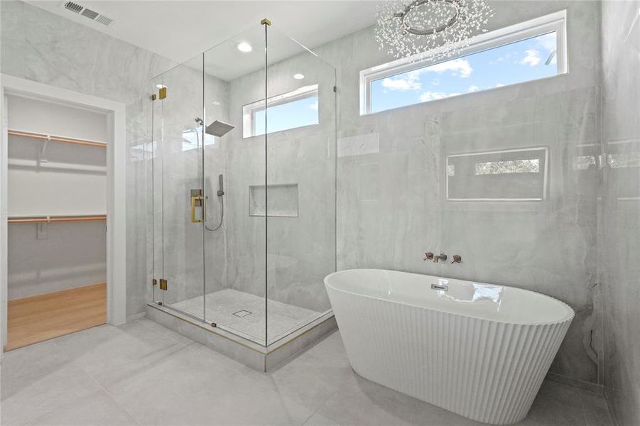Bathroom featuring a freestanding bath, a stall shower, a walk in closet, and tile patterned flooring Bathroom featuring a freestanding bath, a stall shower, a walk in closet, and tile patterned flooring