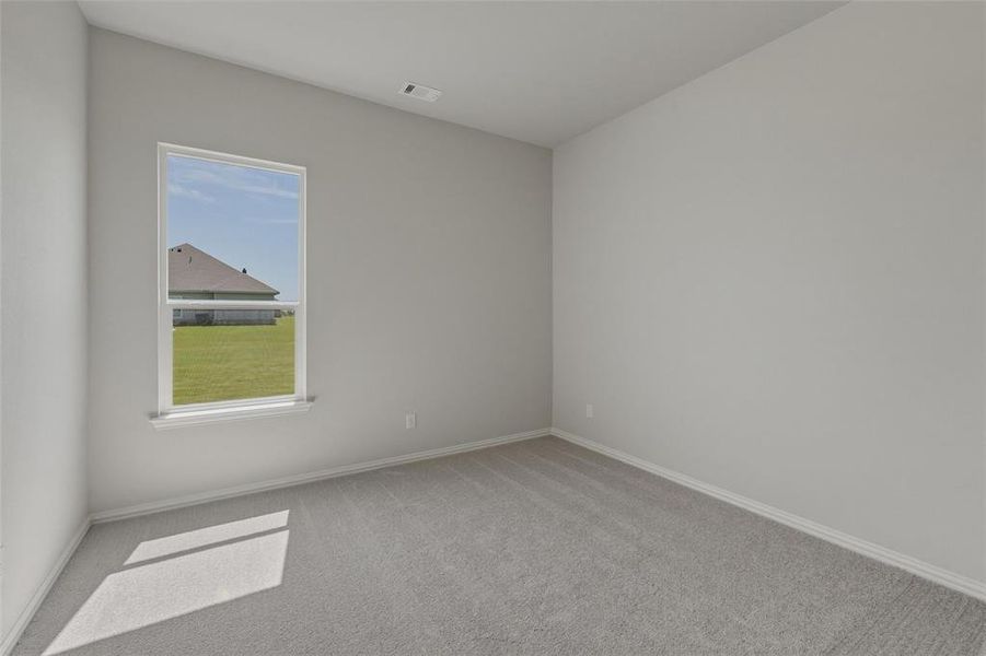 Carpeted interior room with light grey walls and white trim Carpeted interior room with light grey walls and white trim