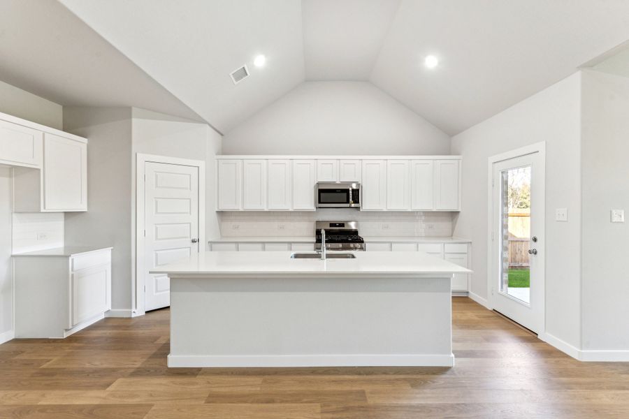 Kitchen in the Wimbledon home plan by Trophy Signature Homes – REPRESENTATIVE PHOTO