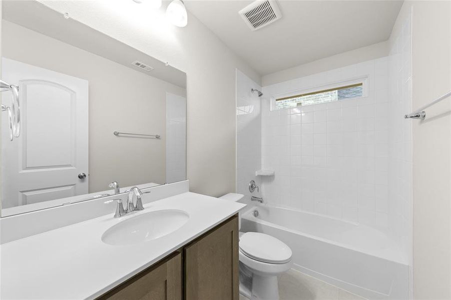 Full bathroom with bathtub / shower combination, toilet, and vanity