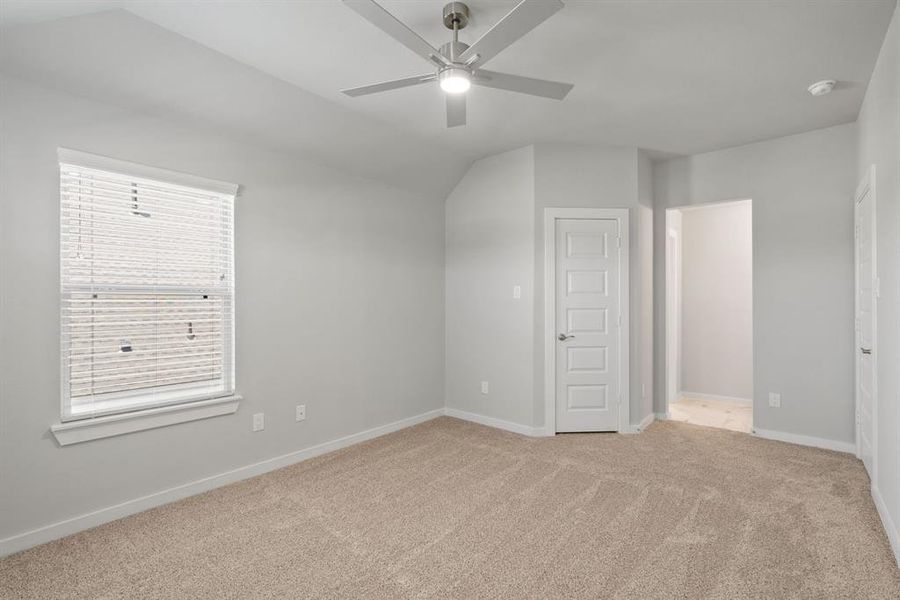 Elegance meets functionality in the secondary bedrooms, showcasing 5-panel doors with modern hardware, large windows adorned with privacy blinds, and walk-in closets boasting sleek and contemporary finishes. Sample photo of completed home with similar floor plan. Actual colors and selections may vary.