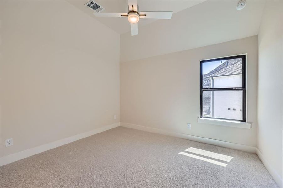 Carpeted empty room with ceiling fan