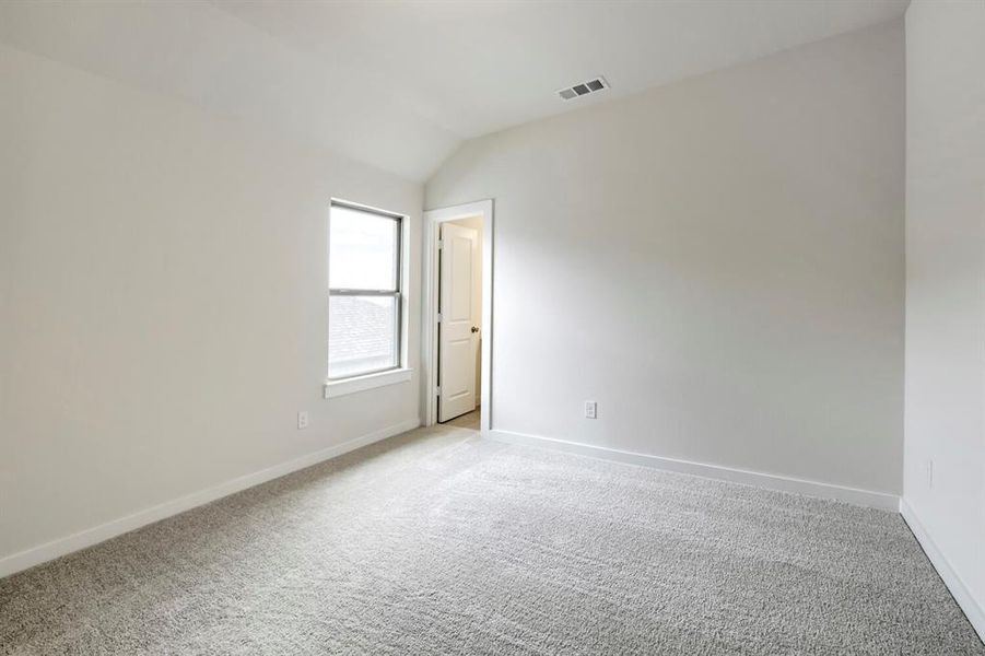 Room featuring light gray wall paint, a single window with white trim, and light gray carpeting Room featuring light gray wall paint, a single window with white trim, and light gray carpeting