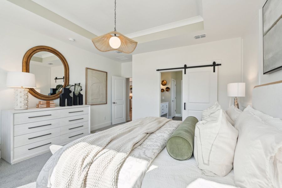 Primary suite with sliding barn door to private bath