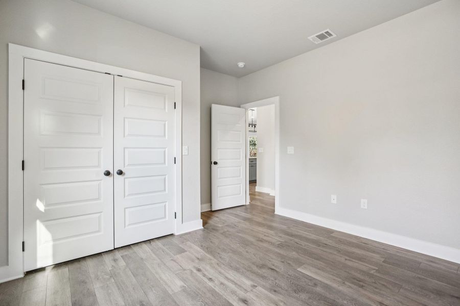 Unfurnished bedroom with light wood-type flooring and a closet