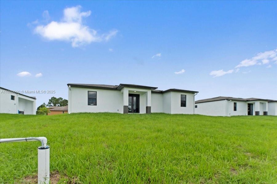 Front exterior of a new home in , Lehigh Acres, FL, highlighting curb appeal (Image 12). Front exterior of a new home in , Lehigh Acres, FL, highlighting curb appeal (Image 12).