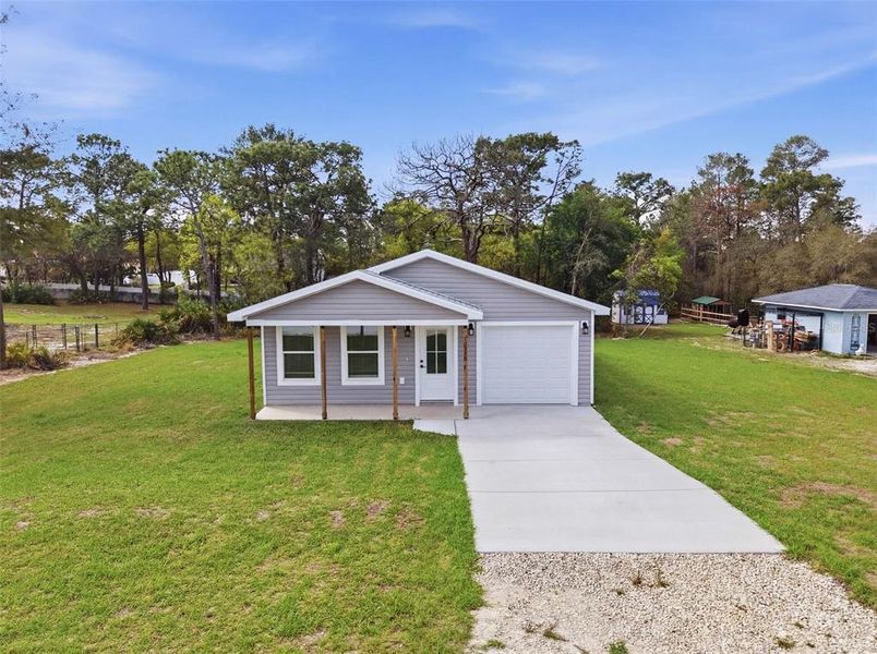 Front exterior of a new home in , Weeki Wachee, FL, highlighting curb appeal (Image 25).