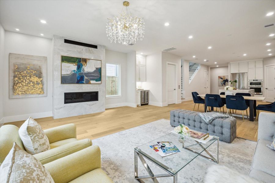 Living room - located on the first floor. It has an accented wall with gas fireplace and a sparkling chandelier. Living room - located on the first floor. It has an accented wall with gas fireplace and a sparkling chandelier.