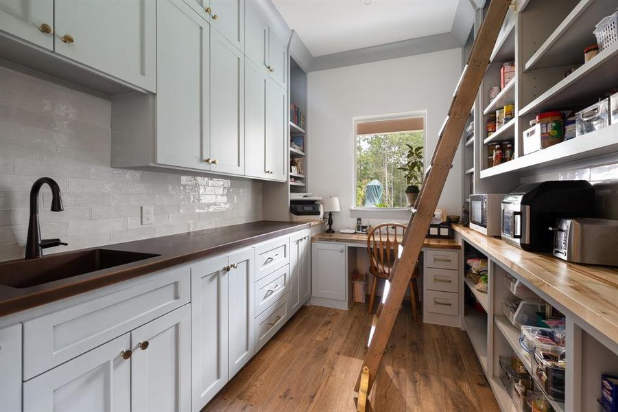 Massive pantry located adjacent to the kitchen with plenty of storage and workspaces.