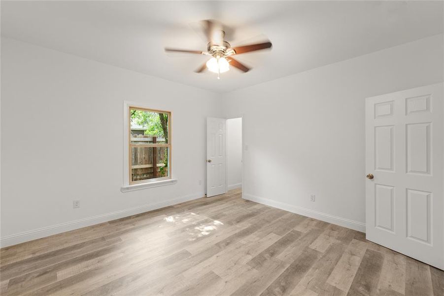 Unfurnished room featuring ceiling fan and light wood-type flooring