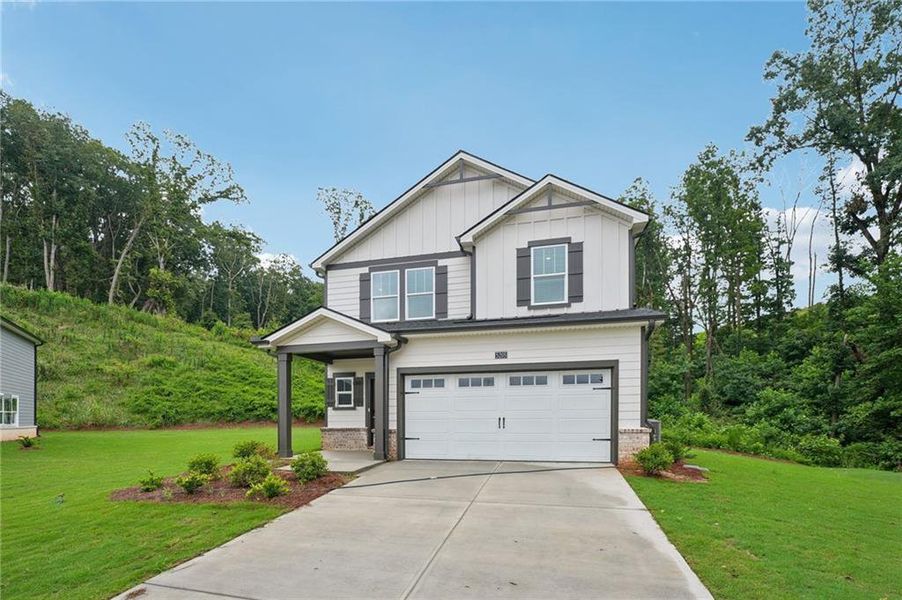 Front exterior of a new home in Hemingway - Reserve Series, Cumming, GA, highlighting curb appeal (Image 28). Front exterior of a new home in Hemingway - Reserve Series, Cumming, GA, highlighting curb appeal (Image 28).