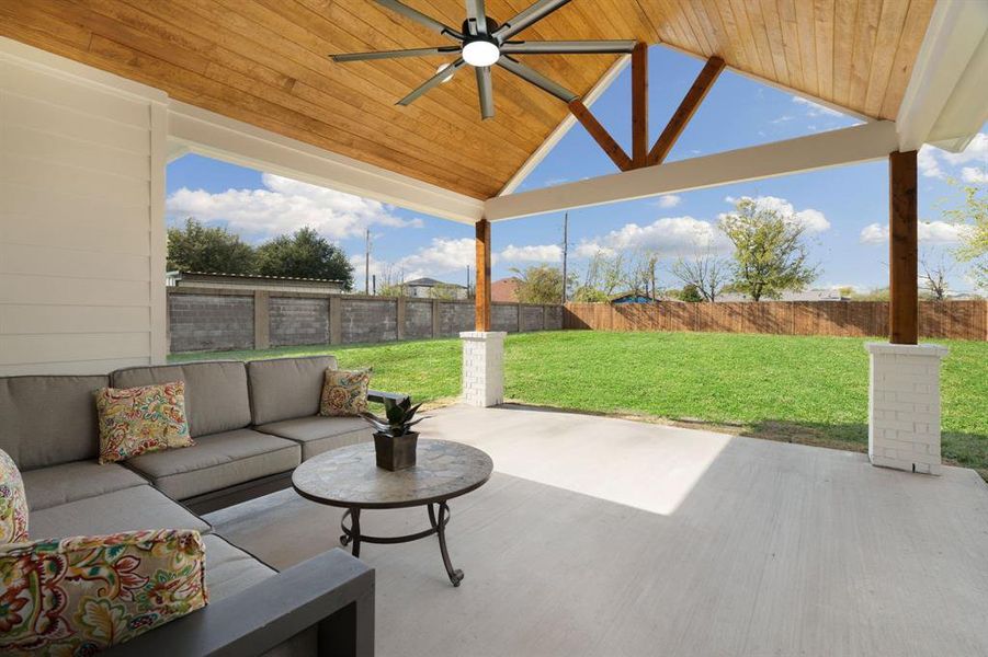 Fenced backyard with a ceiling fan, an outdoor living space, and a patio area Fenced backyard with a ceiling fan, an outdoor living space, and a patio area