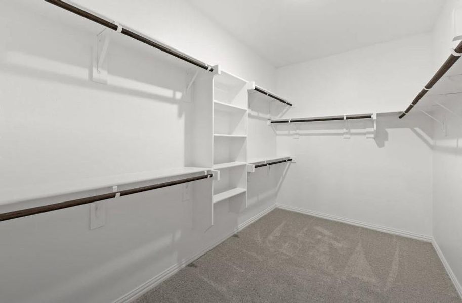 A stylish walk-in closet awaits, providing ample storage for your wardrobe and a little extra room for those cherished items. A stylish walk-in closet awaits, providing ample storage for your wardrobe and a little extra room for those cherished items.