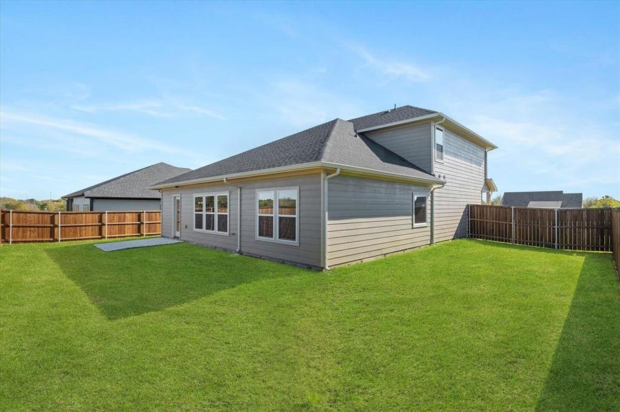 Rear view of house with a lawn Rear view of house with a lawn