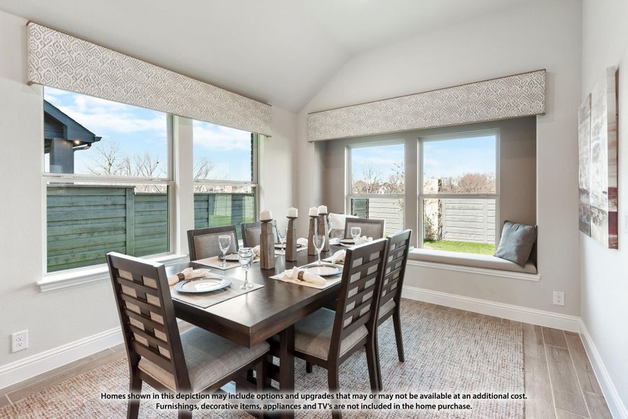 Dining room with dark wood table, six chairs, window seat, and large windows with natural light