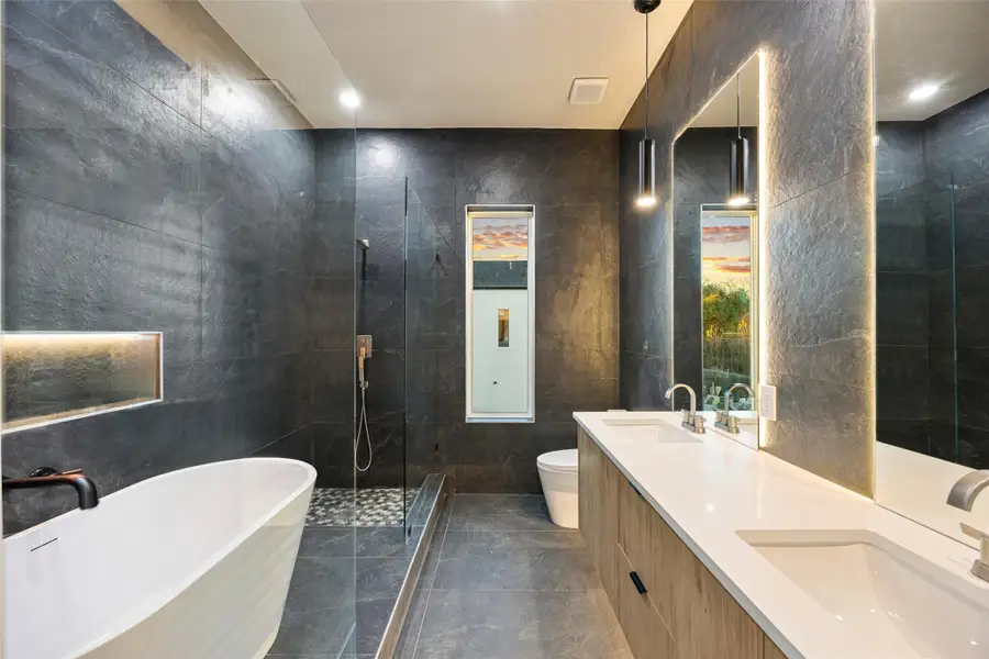 Soaking tub, travertine walls, double sinks — a bath that sells the whole house * Soaking tub, travertine walls, double sinks — a bath that sells the whole house *