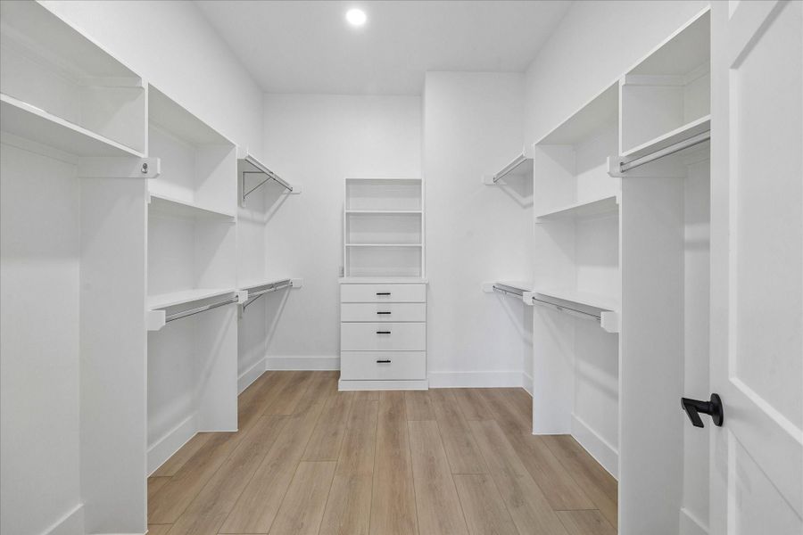 Custom built in shelving, drawer storage, and dedicated display space maximize organization without sacrificing style.