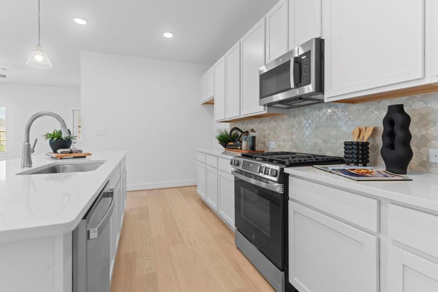 The open layout keeps the kitchen connected to the dining and family areas, making it easy to stay part of the conversation while preparing meals.