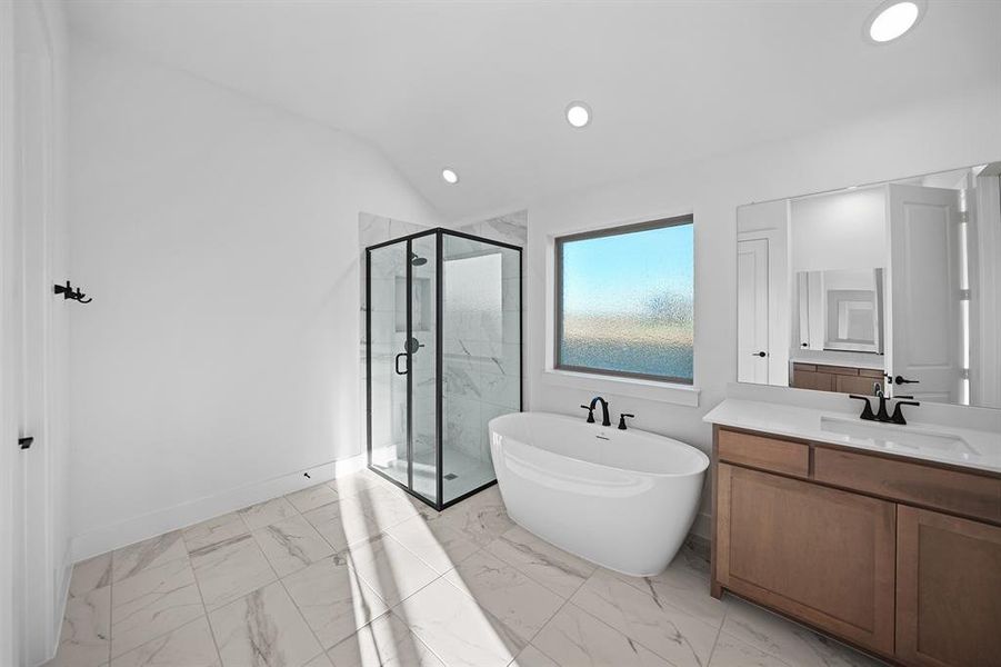 Bathroom featuring vanity, a soaking tub, a marble finish shower, vaulted ceiling, and light marble finish flooring Bathroom featuring vanity, a soaking tub, a marble finish shower, vaulted ceiling, and light marble finish flooring