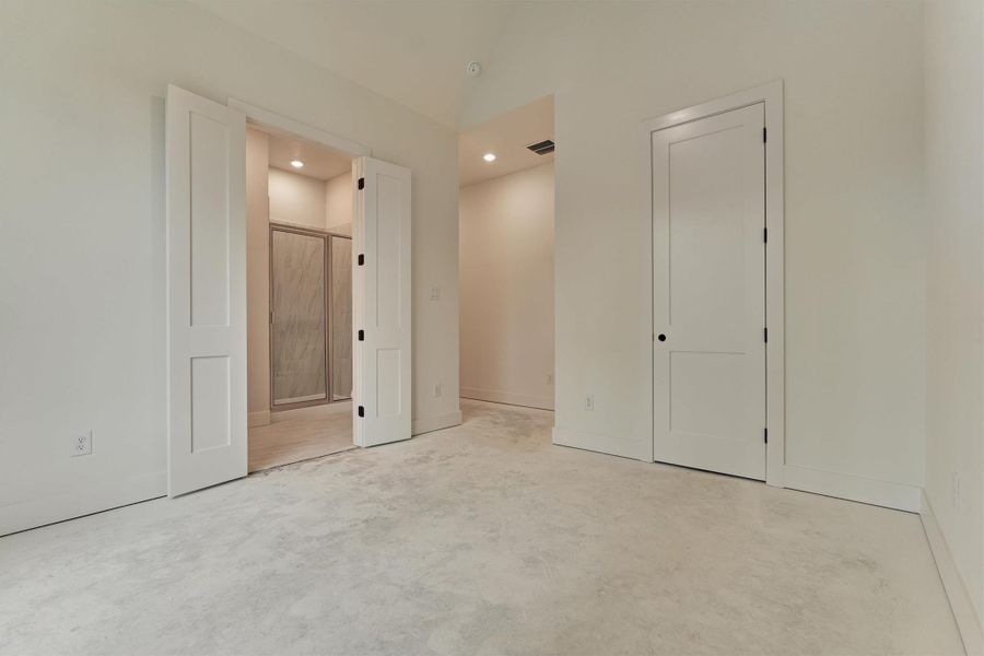 Spacious bedroom with clean modern lines and direct access to a beautifully finished en-suite bath.