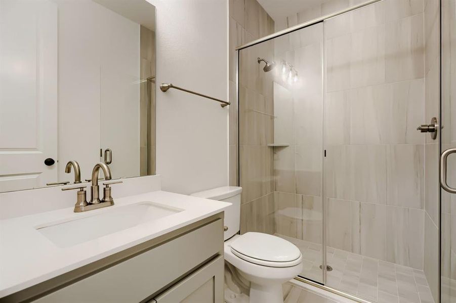 Bathroom with vanity and a shower stall