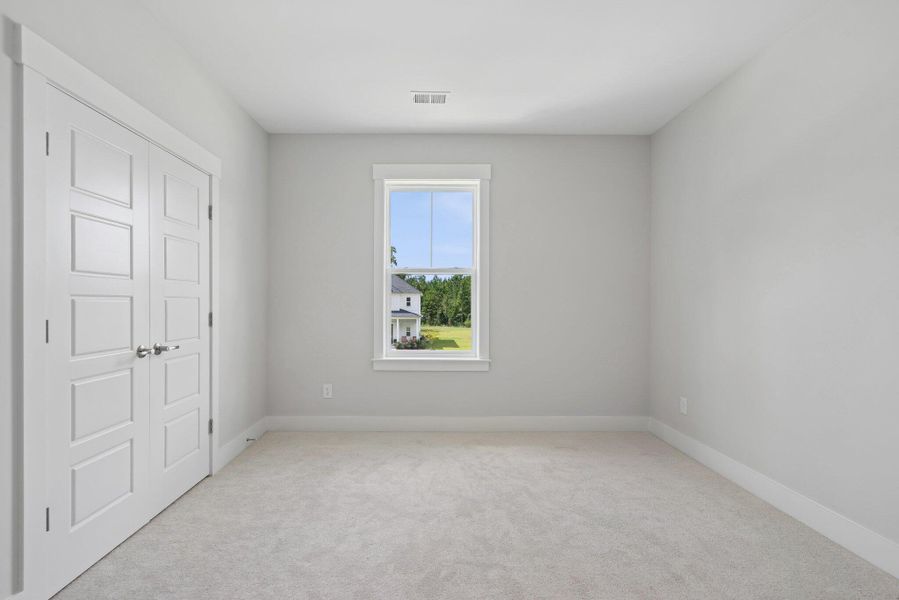 Spacious, unfurnished interior of a new home in Hidden Ponds Reserve, Awendaw (Image 42).